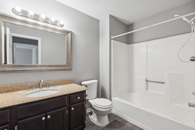 full bathroom featuring toilet, a textured ceiling, shower / tub combination, vanity, and hardwood / wood-style floors