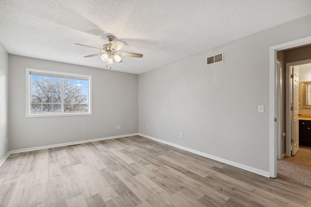 unfurnished room featuring a textured ceiling, ceiling fan, and light wood-type flooring