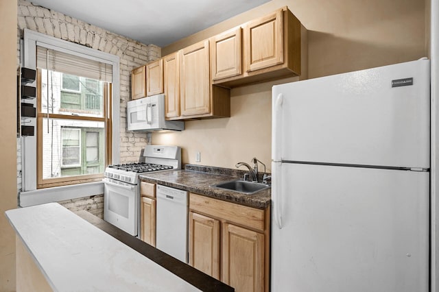 kitchen with white appliances, sink, and light brown cabinets