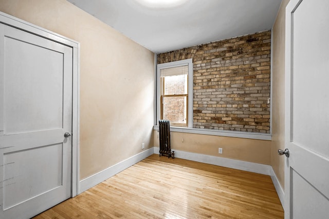 unfurnished bedroom with a closet and light wood-type flooring