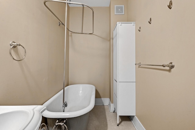 bathroom featuring a washtub and tile patterned floors