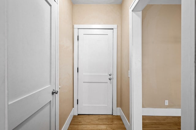 corridor with light hardwood / wood-style flooring