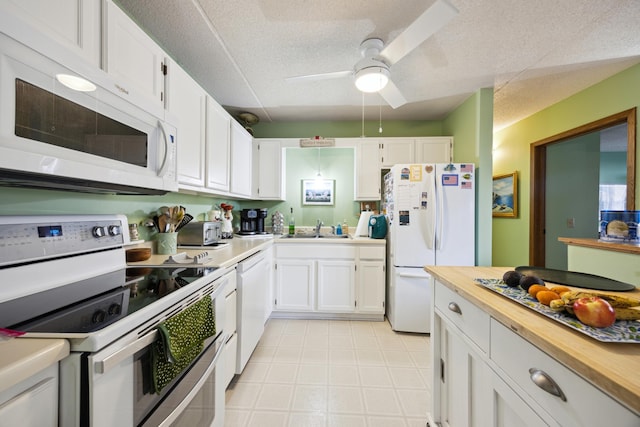 kitchen featuring white cabinetry, white appliances, ceiling fan, and sink