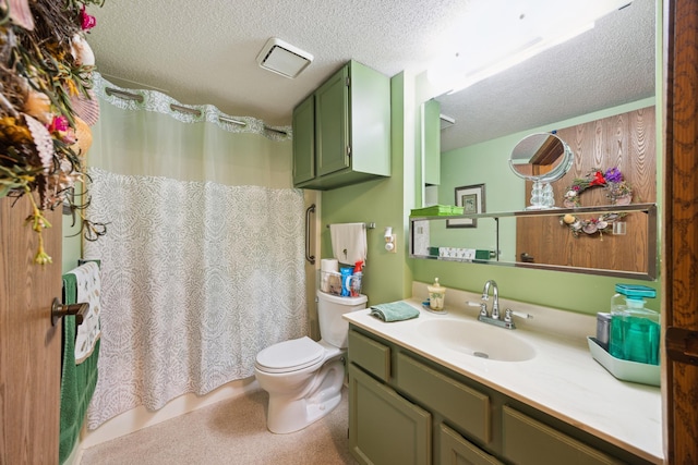 bathroom with vanity, toilet, and a textured ceiling