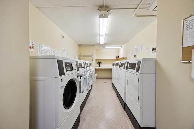 laundry room with washer and clothes dryer and a textured ceiling