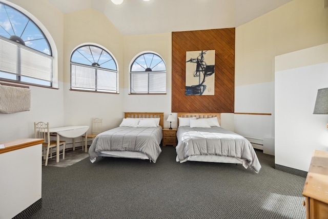 bedroom with multiple windows, carpet, and wood walls