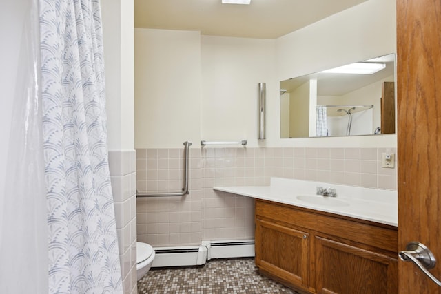 bathroom featuring tile walls, vanity, curtained shower, tile patterned floors, and toilet