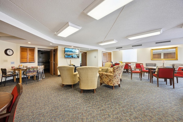 carpeted living room featuring a textured ceiling