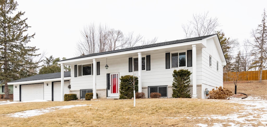 bi-level home with a garage and a front yard