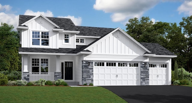 view of front facade with a garage, covered porch, and a front yard