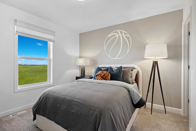 bedroom featuring light colored carpet