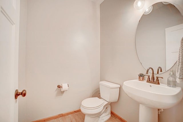 bathroom featuring sink, hardwood / wood-style floors, and toilet