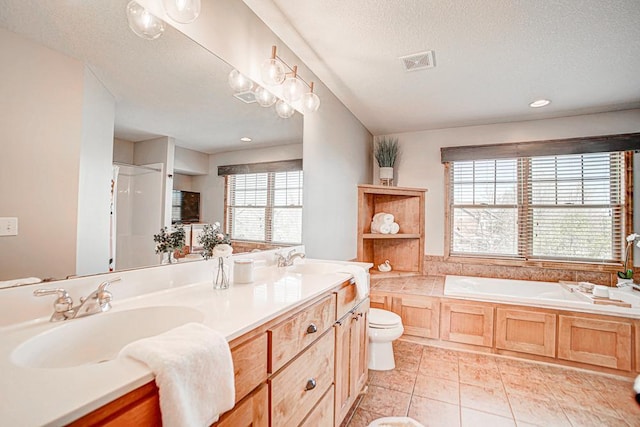 full bathroom featuring tile patterned flooring, vanity, plus walk in shower, a textured ceiling, and toilet