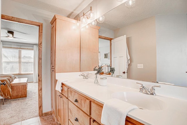 bathroom with vanity, tile patterned floors, and a textured ceiling