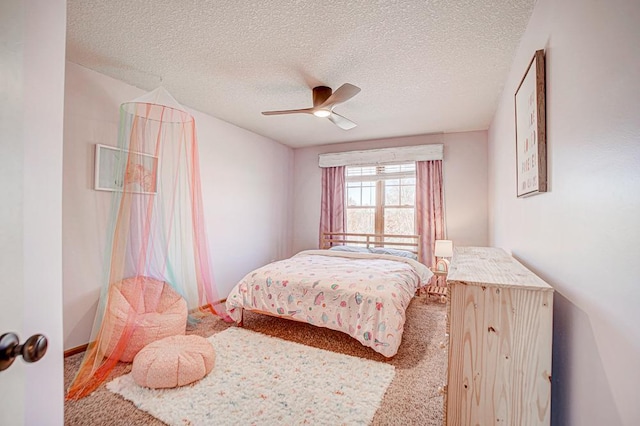 carpeted bedroom featuring ceiling fan and a textured ceiling