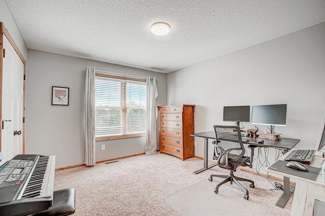 home office featuring carpet flooring and a textured ceiling