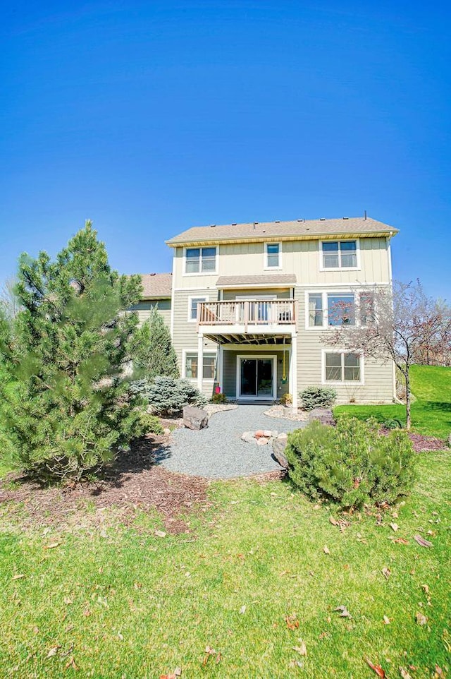 back of house with a lawn, a patio, and a deck