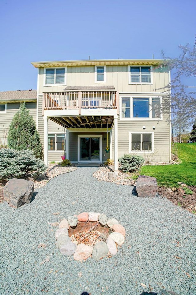 rear view of property featuring a deck