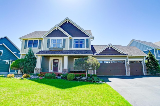 craftsman-style home featuring a garage and a front yard