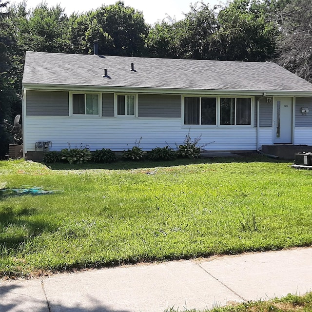 ranch-style house featuring central AC and a front lawn