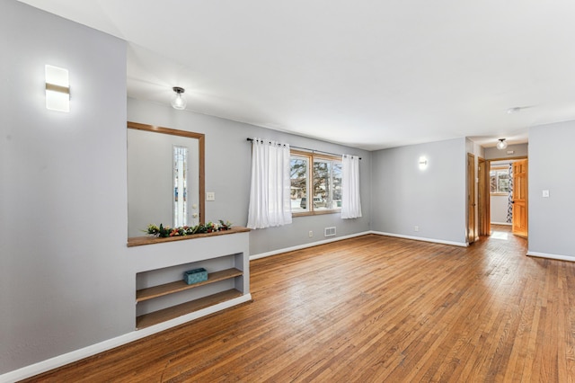 unfurnished living room with hardwood / wood-style flooring