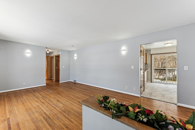 unfurnished living room featuring hardwood / wood-style flooring