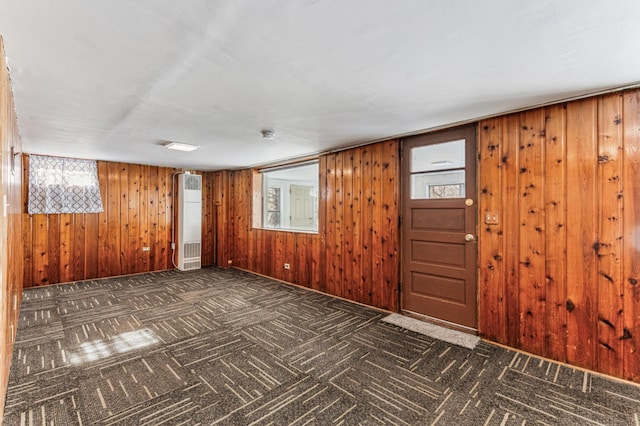 foyer entrance with wooden walls