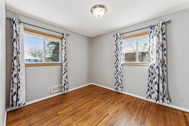 unfurnished room featuring hardwood / wood-style flooring