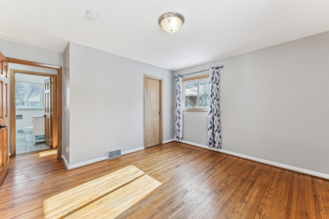 spare room with hardwood / wood-style flooring