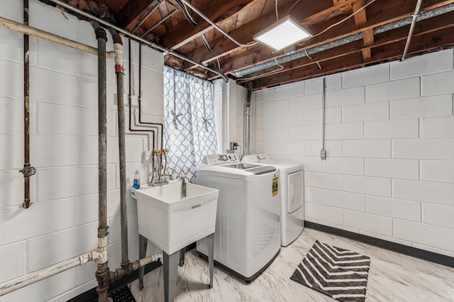 laundry room featuring separate washer and dryer and sink