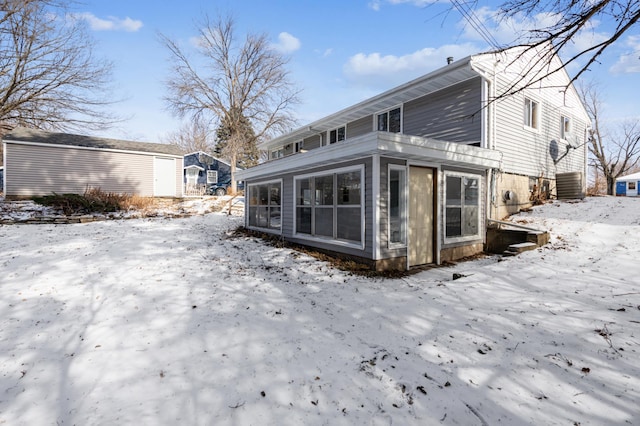 view of snow covered exterior featuring central AC unit