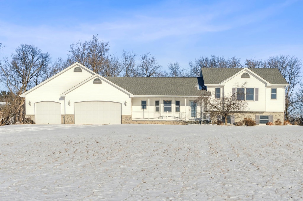 tri-level home with a porch and a garage