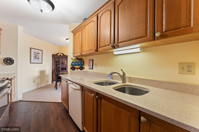 kitchen featuring sink, light stone counters, stainless steel range oven, and white dishwasher