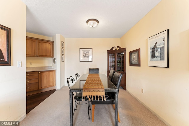 dining area with dark carpet