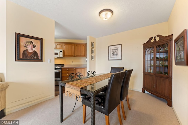 dining area with light colored carpet