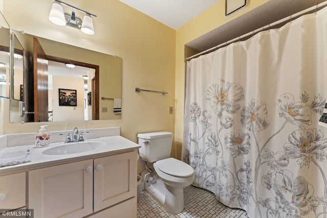 bathroom featuring a shower with curtain, vanity, toilet, and tile patterned flooring