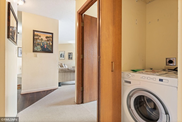 clothes washing area with washer / dryer and carpet floors