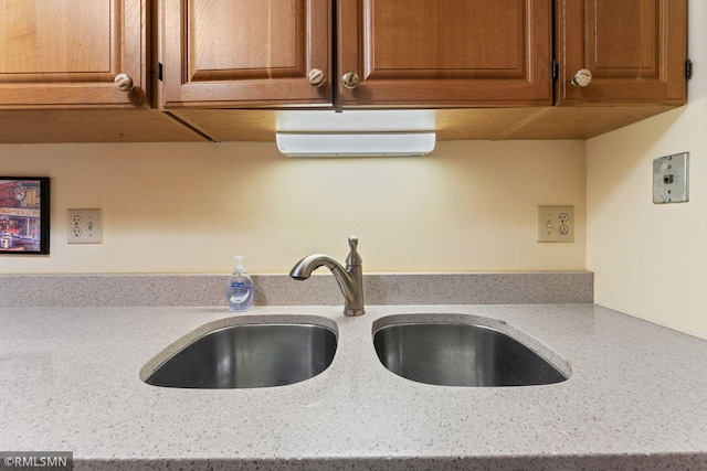 interior details with light stone countertops and sink