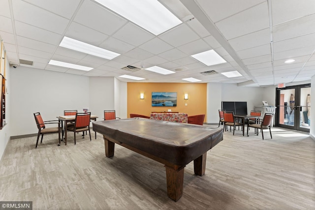 game room with a drop ceiling, light hardwood / wood-style flooring, billiards, and french doors