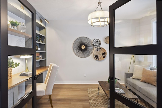 office featuring hardwood / wood-style flooring and a chandelier