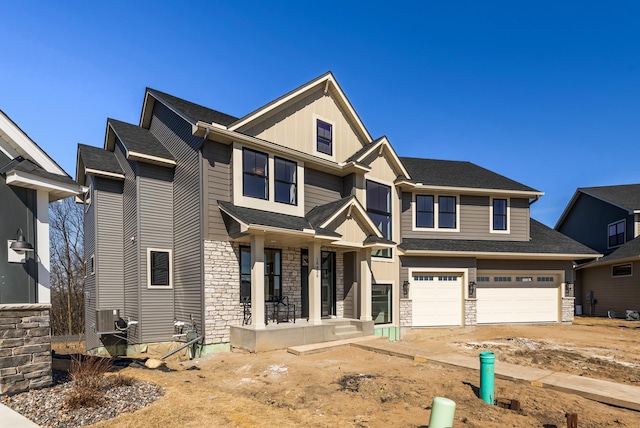 18436 56th Ct N, Plymouth, MN 55446 - view of front of property with a garage, driveway, covered porch, stone siding, and board and batten siding