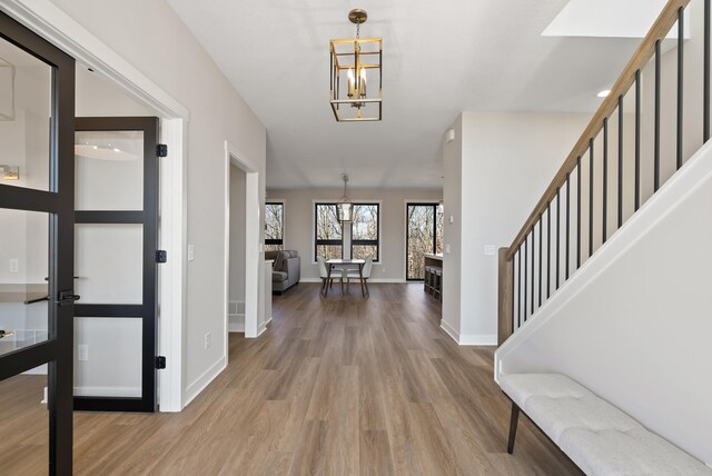 18436 56th Ct N, Plymouth, MN 55446 - foyer entrance featuring a chandelier, wood finished floors, stairway, and baseboards
