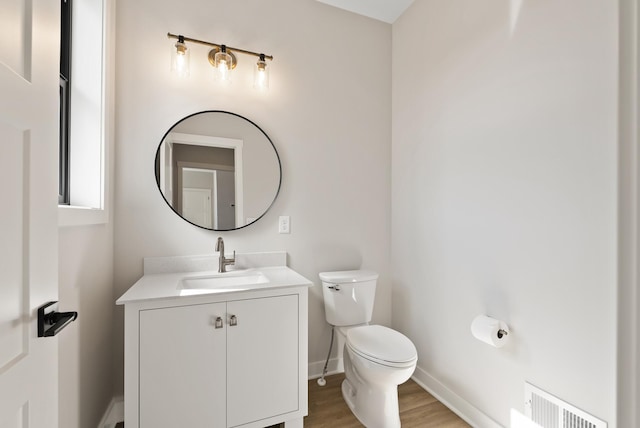 18436 56th Ct N, Plymouth, MN 55446 - half bath with wood finished floors, toilet, vanity, and baseboards
