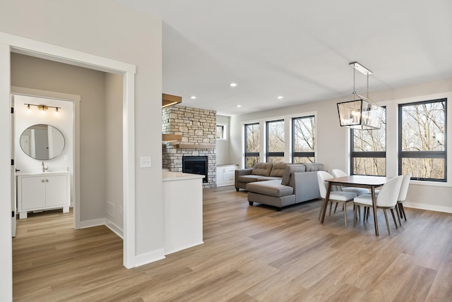 18436 56th Ct N, Plymouth, MN 55446 - living room with light wood-style floors, a chandelier, a fireplace, recessed lighting, and baseboards