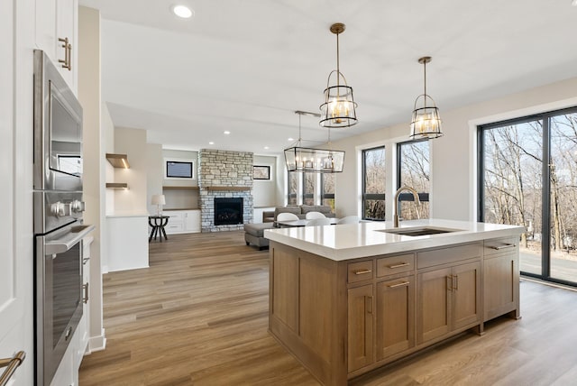 18436 56th Ct N, Plymouth, MN 55446 - kitchen with a sink, a fireplace, healthy amount of natural light, light countertops, and recessed lighting