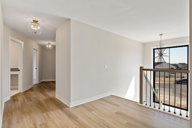 18436 56th Ct N, Plymouth, MN 55446 - empty room with a chandelier, light wood finished floors, and baseboards