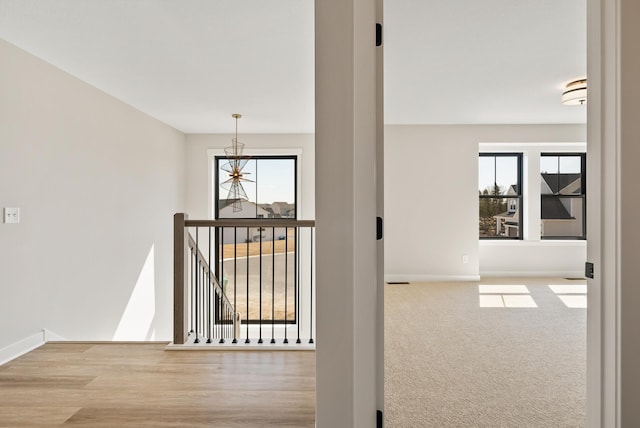 18436 56th Ct N, Plymouth, MN 55446 - hallway with an upstairs landing, baseboards, plenty of natural light, and a chandelier