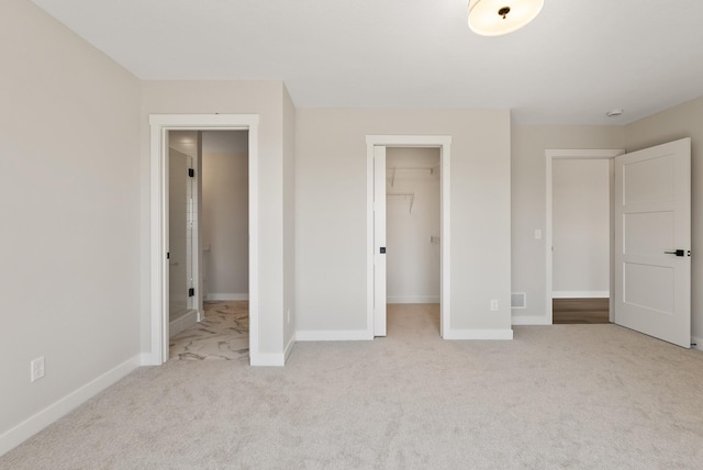 18436 56th Ct N, Plymouth, MN 55446 - unfurnished bedroom with carpet, baseboards, a walk in closet, and a closet