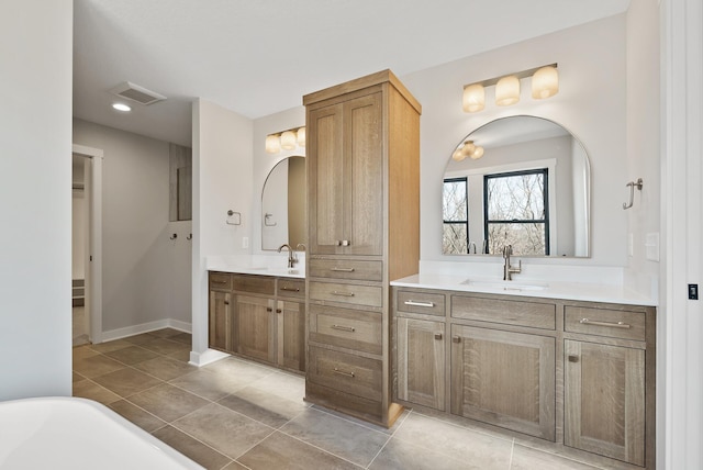 18436 56th Ct N, Plymouth, MN 55446 - bathroom with two vanities, a freestanding bath, tile patterned flooring, baseboards, and recessed lighting