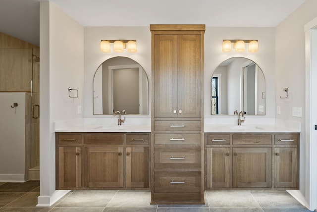 18436 56th Ct N, Plymouth, MN 55446 - full bathroom featuring two vanities, a stall shower, baseboards, and tile patterned flooring